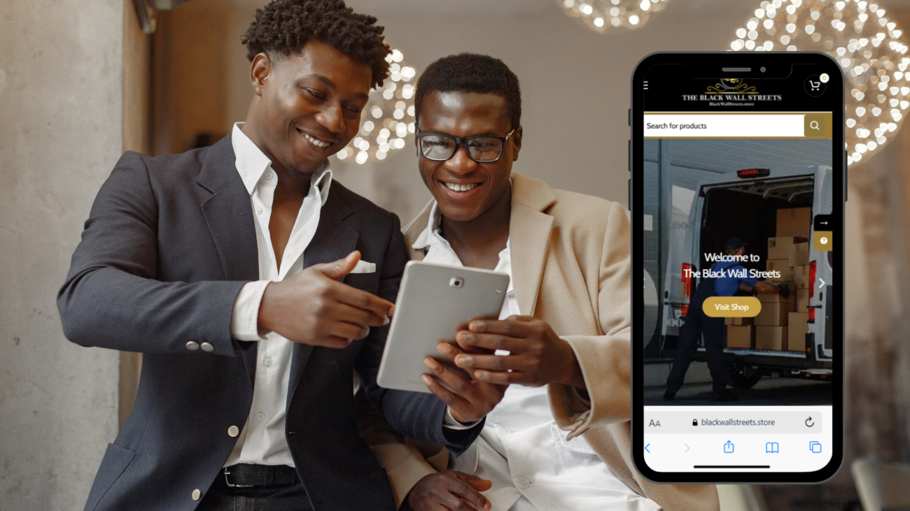 Two men in suits examining a tablet displaying a mobile app for a Black-owned business directory and marketplace.