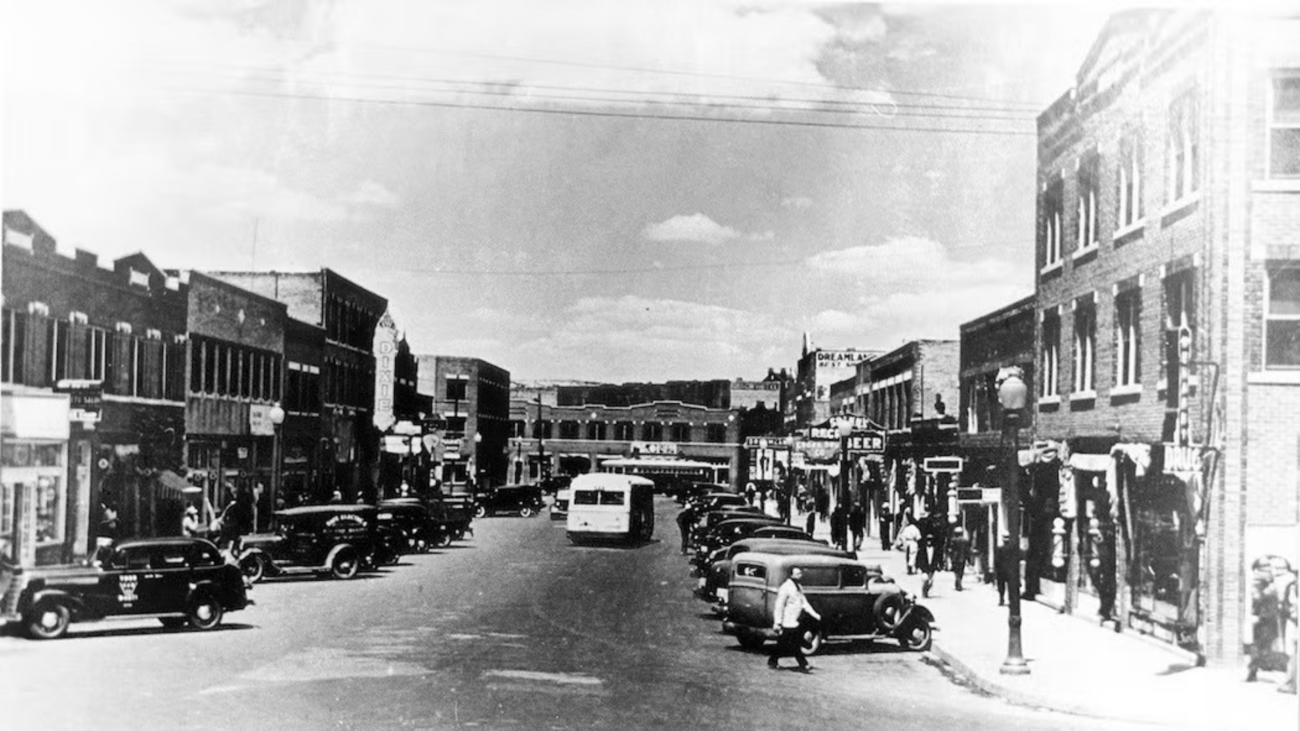 An old black and white photo depicting a bustling city street, symbolizing the legacy of Black Wall Street communities.