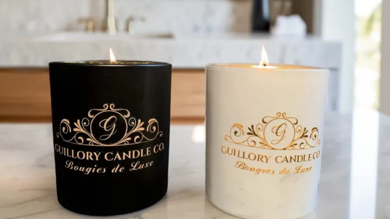 Two candles on a counter, labeled with "Gillow Candle Company," representing wellness and self-care products.