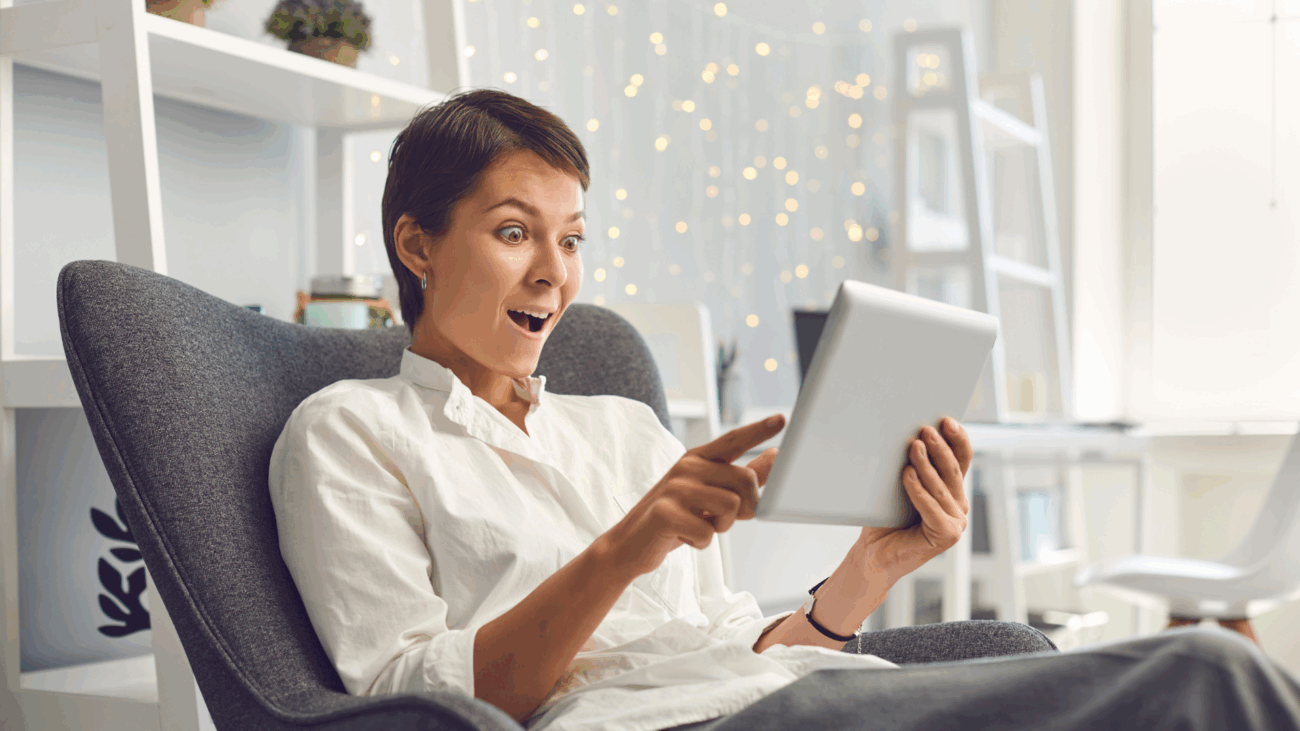 A woman sitting in a chair, focused on a tablet, representing a user-friendly online shopping experience.