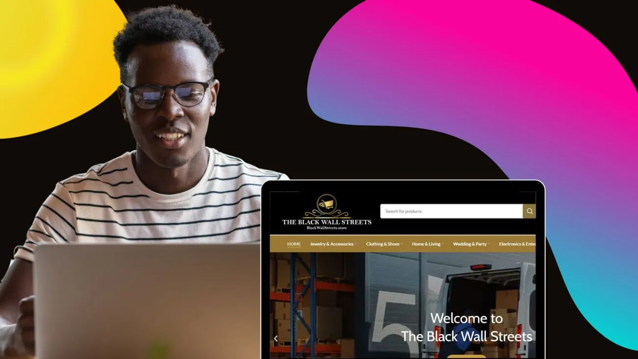 A man in glasses focuses intently on a laptop screen, engaging with online content about Black-owned businesses.
